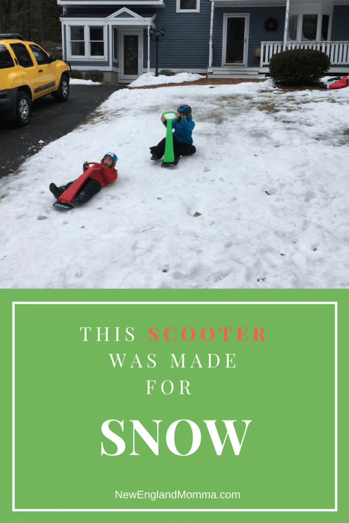 kids outside the home going sledding with a ski scooter